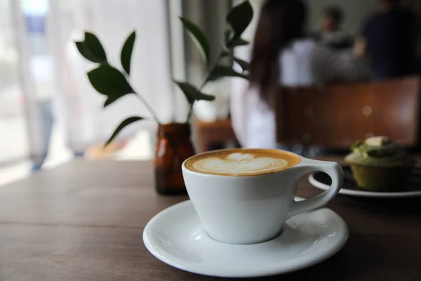 Cappuccino coffee on wood background — Stock Photo, Image