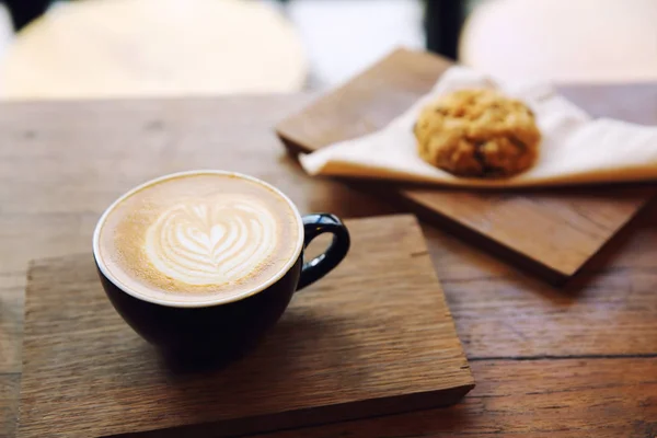 Cappuccino koffie met koekje op houten achtergrond — Stockfoto