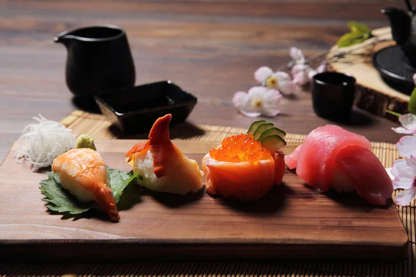 Sushi Set sashimi and sushi rolls with tea on wood background — Stock Photo, Image