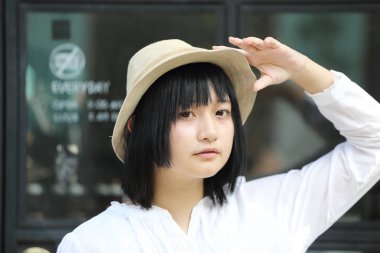 Asyalı genç kadın düşünme ve portre ile kahve s arıyor