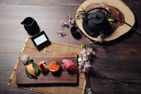 寿司集的生鱼片和寿司卷与茶木背景 — 图库照片