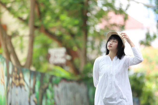 Asian young woman thinking and looking travel concept portrait w