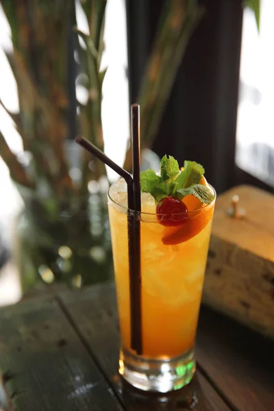 Mai tai cocktail with orange cherry fruits on wood background — Stock Photo, Image