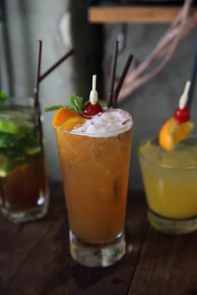 Mai tai cocktail with orange cherry fruits on wood background — Stock Photo, Image