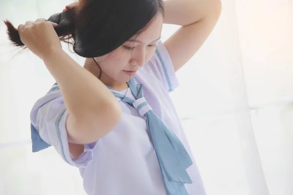 School girl getting dressed on white room — Stock Photo, Image