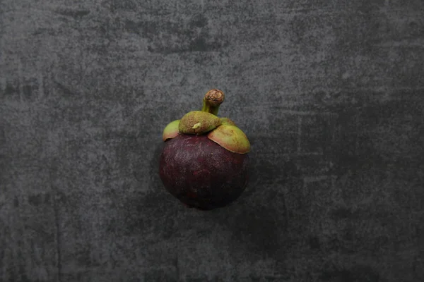 Mangosteen fruit on dark rock background — Stock Photo, Image