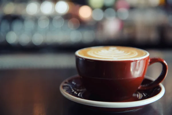 Cappuccino coffee on coffee bar in dark tone