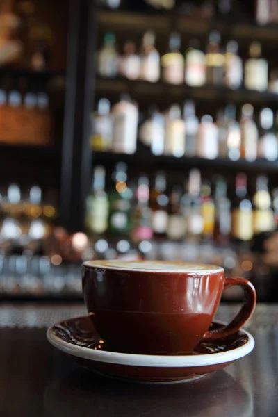 Cappuccino coffee on coffee bar in dark tone