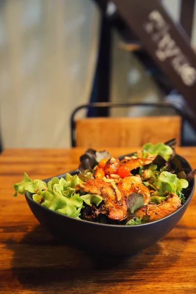 Chicken salad on wood background in restaurant lgiht — Stock Photo, Image