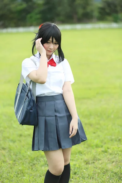 portrait of japanese school girl outdoor in countryside