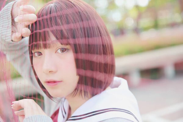 Portrait of Japanese school girl with countryside park