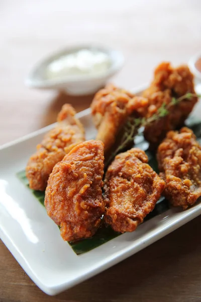 Buffalo wings barbecue chicken with carrots  and cucumbers on wo — Stock Photo, Image