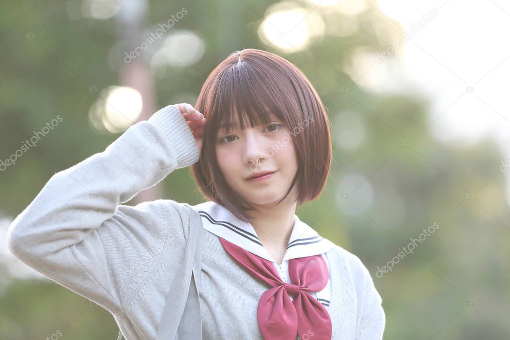 Portrait of Japanese school girl with countryside park
