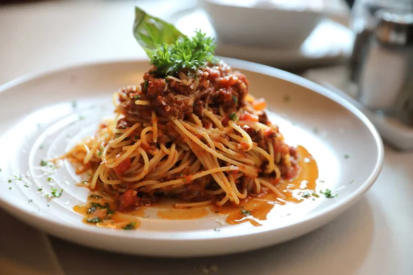 Spaghetti Bolognese with minced beef and tomato sauce garnished — Stock Photo, Image