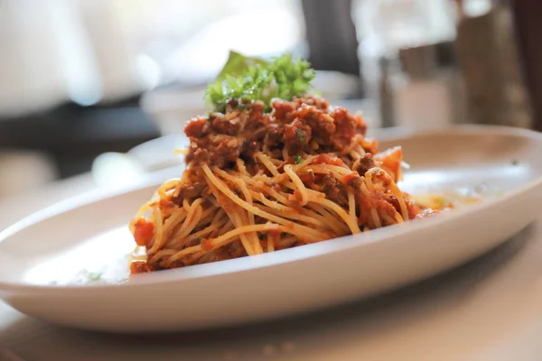 Spaghetti Bolognese with minced beef and tomato sauce garnished — Stock Photo, Image