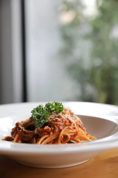 Spaghetti Bolognese with minced beef and tomato sauce garnished — Stock Photo, Image