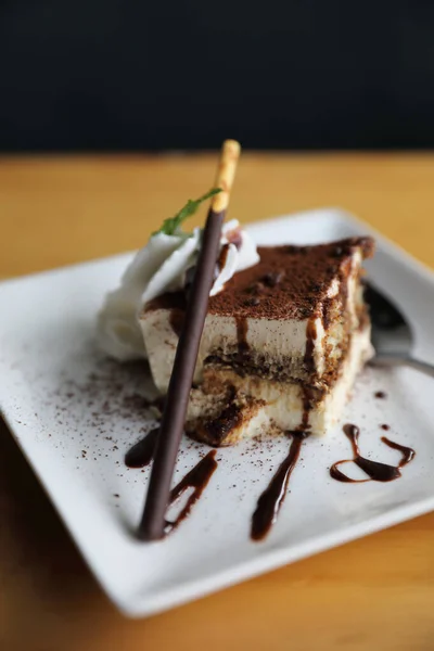 Tiramisu cake dessert with cream mint and chocolate sauce on woo — Stock Photo, Image