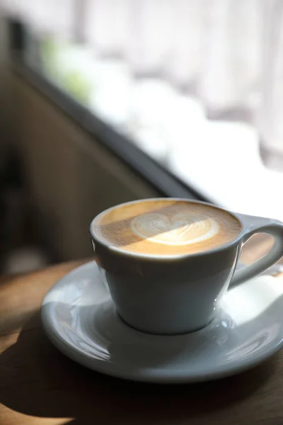 Cappuccino or Latte art coffee made from milk on the wood table — Stock Photo, Image