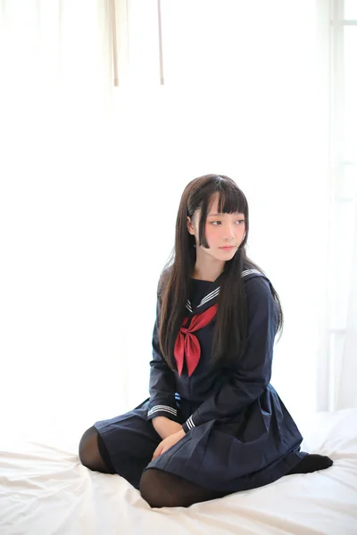 Portrait japanese school girl in white tone bed room — Stock Photo, Image