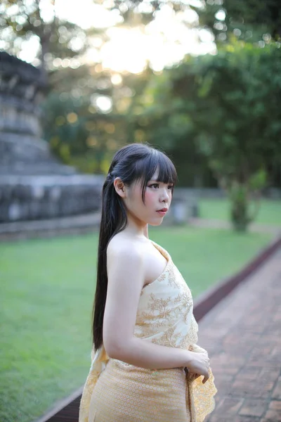 Portrait of Thai female with traditional Thai dress with temple — Stok Foto