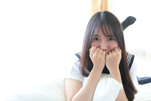 Portrait japanese school girl in white tone bed room — Stock Photo, Image