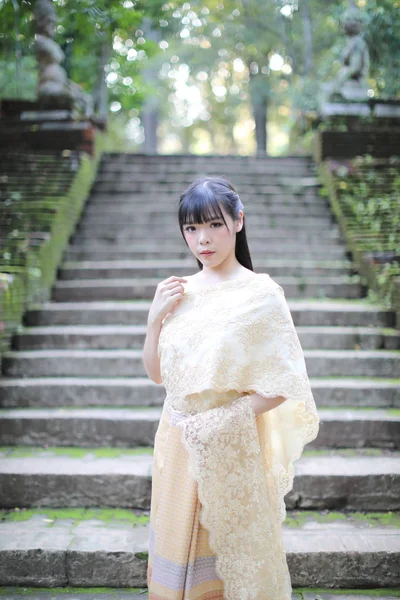 Portrait of Thai female with traditional Thai dress with temple — Stok Foto