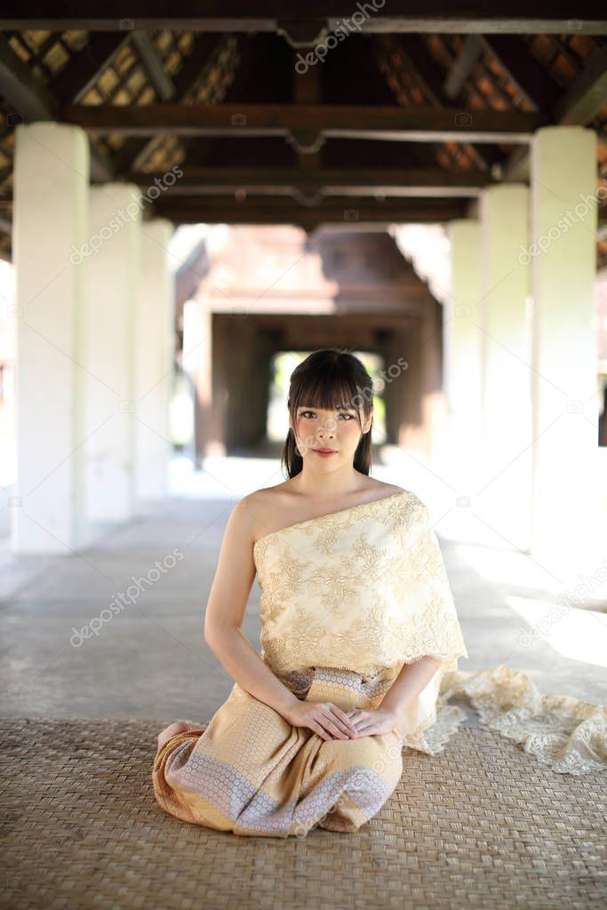 Portrait of Thai female with traditional Thai dress sitting with