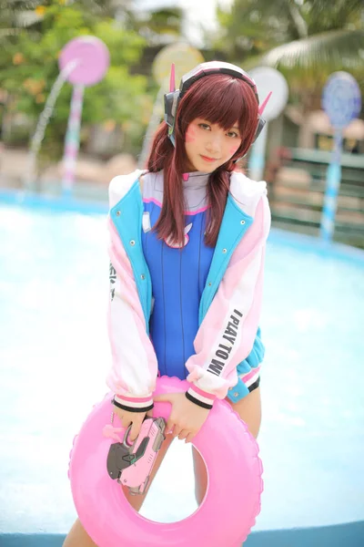 Japan anime cosplay , portrait of cosplay girl with swim suit at swimming pool