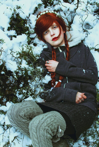 Red hair woman in grey coat in winter