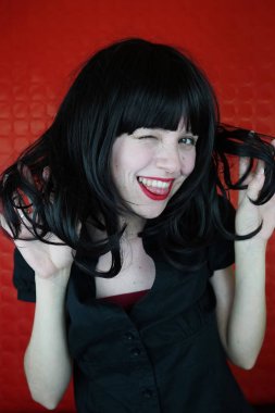 Kırmızı zemin üzerine genç mutlu esmer kadın portresi