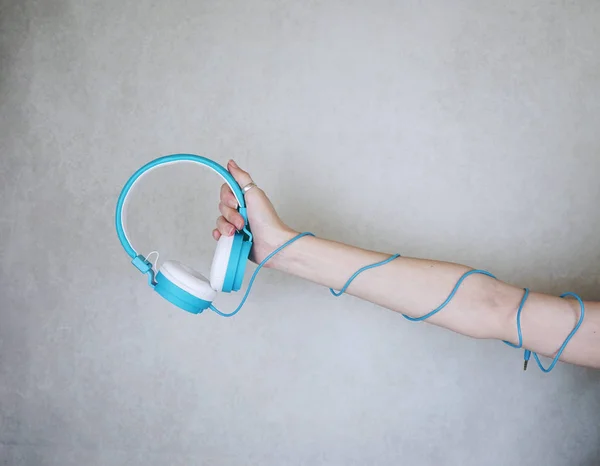 Close Woman Hand Holding Blue Headphones Background — Stock Photo, Image