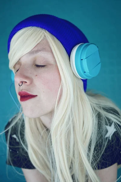 Close Blonde Woman Closed Eyes Blue Hat Headphones Background — Stock Photo, Image