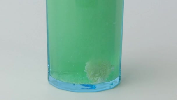Effervescent tablet dissolving in water. — Stock Video