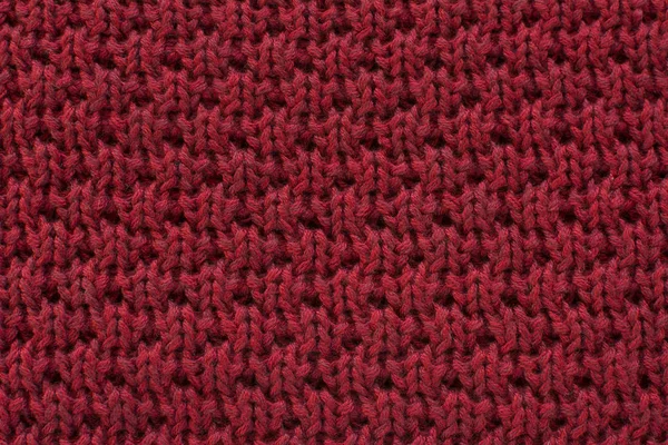 Red knitted wool fabric texture background