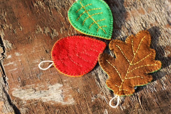 Colored leaves on a wooden background. Handmade leaves