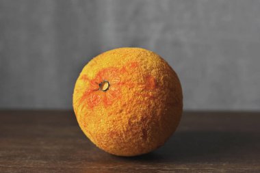 Orange on a gray background. Fruit close up
