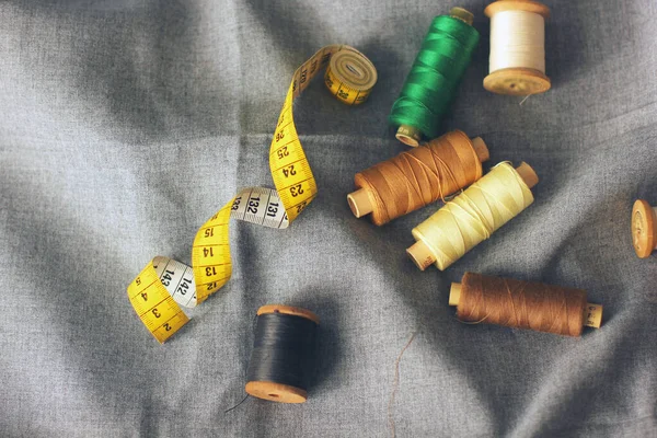 Sewing. Spools of thread on the fabric. Threads. Meter