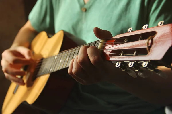 The guy with the guitar. Guitar in the hands of a guy.