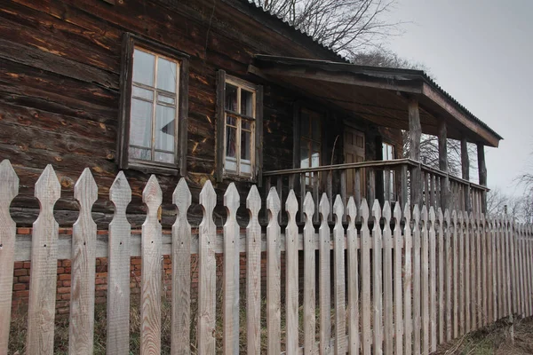 Old house and old fence. House in the village