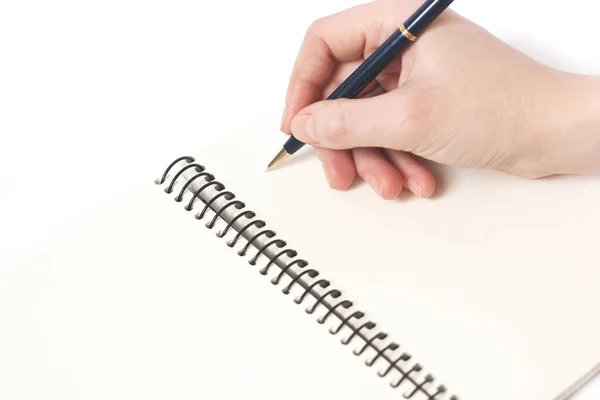 Pen in hand and notebook on a white background