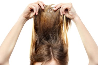 Kız beyaz bir arka planda saçını kaldırdı.