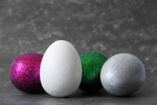 Colored eggs. Beautiful eggs. Eggs on a dark background