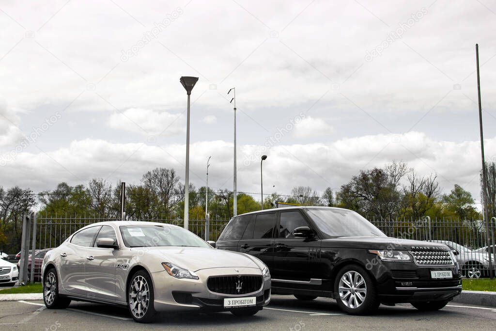 Kiev, Ukraine - April 21, 2020: Luxury car Maserati Quattroport and Range Rover in the city