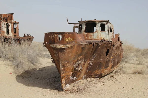 Boats stranded on the now dry bottom of the Aral Sea. The sea has dried up, leaving only sand, seashells, rusty boats and unique and terrible concequences on the region. One of the planet`s worst environmental disasters.
