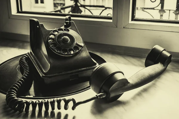 Teléfono viejo está en ventana de vinilo —  Fotos de Stock
