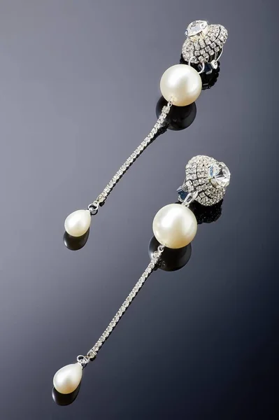 Brincos de jóias de plástico com cristais e pedras para mulheres em um fundo escuro . — Fotografia de Stock
