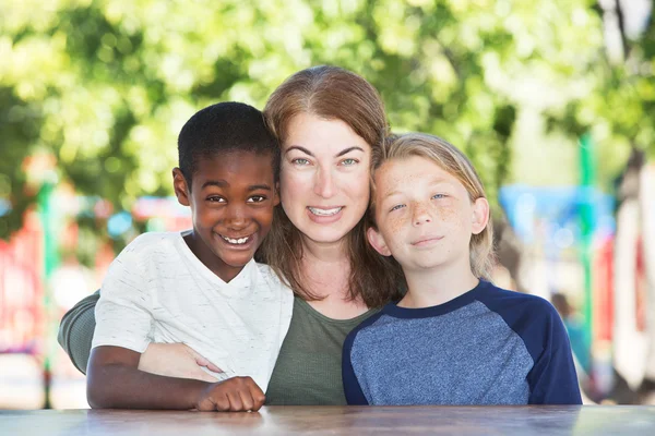 Mother hugging and sitting with boys