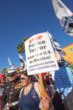 Veterans and family protesting at border clipart