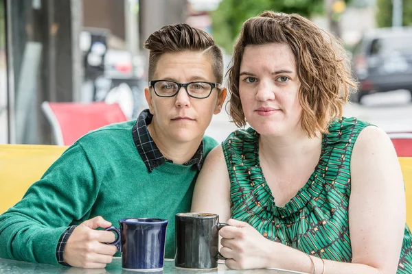 Serious couple outdoors in green dress and sweater — Stock Photo, Image