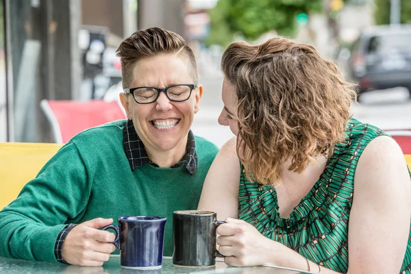 Cute lesbian couple joking outside at bistro — Stock Photo, Image